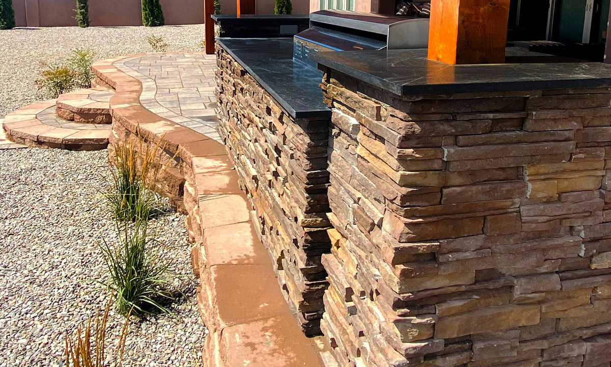 Backyard Outdoor Kitchen Granite Countertop Raised Patio Veneer Belgard Wall